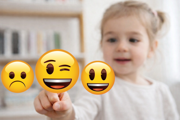 Child pointing at emoji icons representing different emotions.